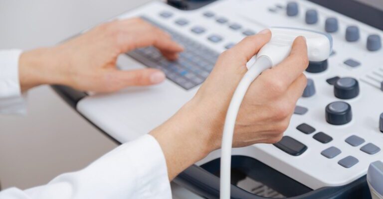 aging-professional-concentrated-sonographer-working-clinic-while-providing-ultrasonic-body-examination-holding-ultrasound-linear-transducer-1536x1024-1-768x512